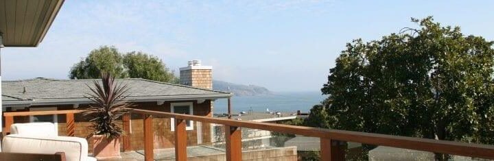 Terrace beside Alta Mira's Sausalito residence with seating and a view toward San Francisco Bay