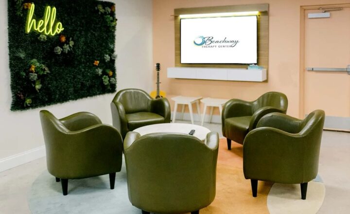 Seating arranged around a low table in a communal room at Beachway Therapy Center