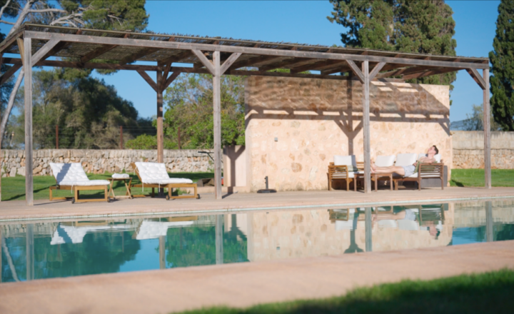 Poolside pergola and lounge chairs pictured on the COGNIFUL website for its Mallorca program