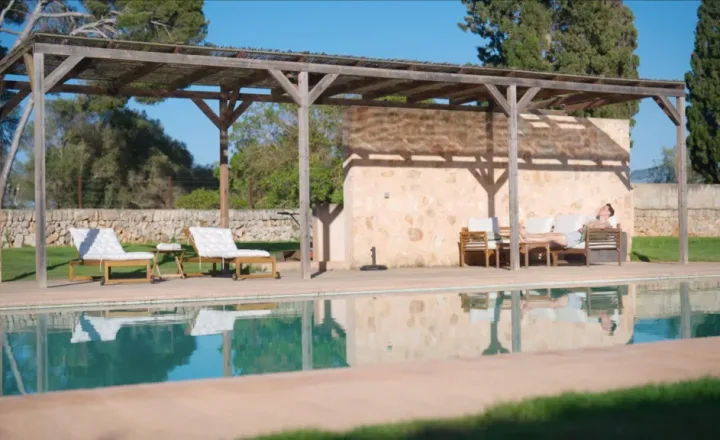 Poolside pergola and lounge chairs pictured on the COGNIFUL website for its Mallorca program