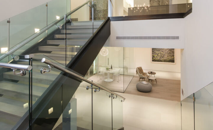Glass-railed staircase and shared seating area inside Carrara House Los Angeles