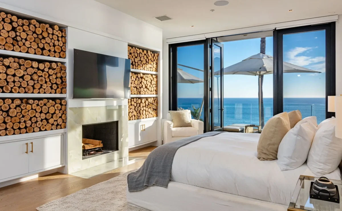 Paradise Cove bedroom at Carrara Malibu, with bed, fireplace and ocean-facing balcony