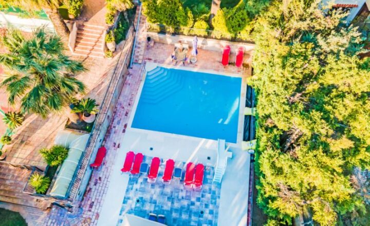 Aerial view of the swimming pool and landscaped grounds at the Go Green Project X retreat in Nea Penteli