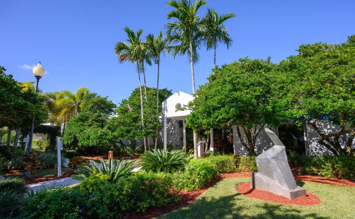 Palm-lined grounds and treatment buildings at Hanley Center in West Palm Beach