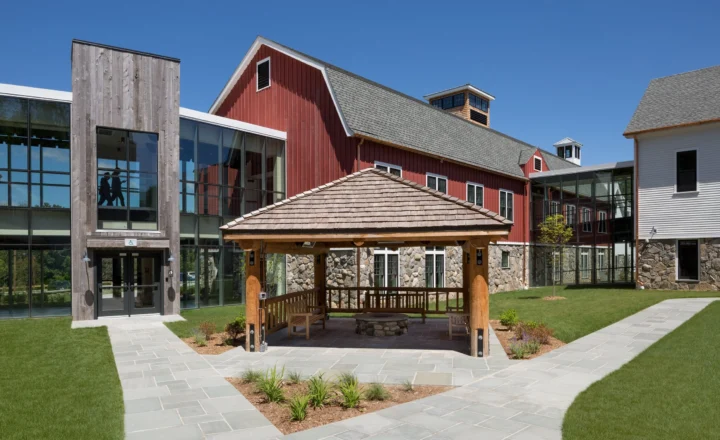 Barn-style treatment building and courtyard at High Watch Recovery Center