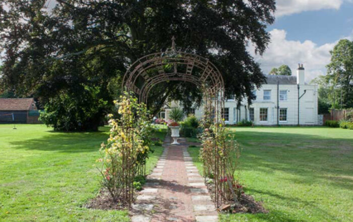 Garden path and manor at Life Works House in Old Woking