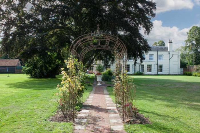 Garden path and manor at Life Works House in Old Woking