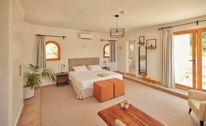 Private bedroom with sitting area and terrace doors at Montgó Lifestyle