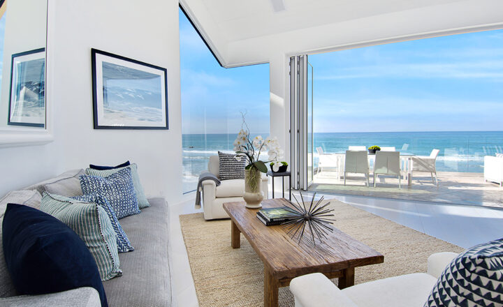 Lounge opening to an ocean-facing terrace in The Pointe Malibu’s official residence tour