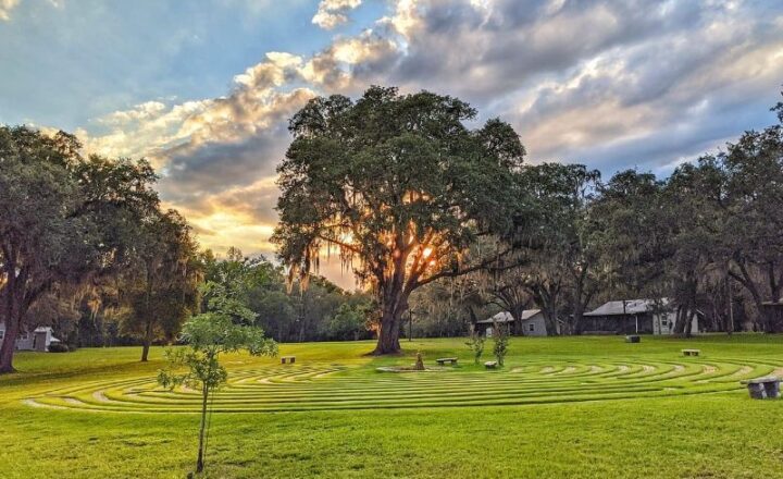 Grass labyrinth and cabin-style buildings on The Refuge campus in Ocklawaha