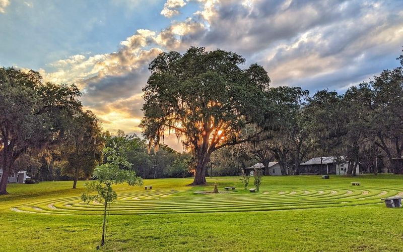 Grass labyrinth and cabin-style buildings on The Refuge campus in Ocklawaha