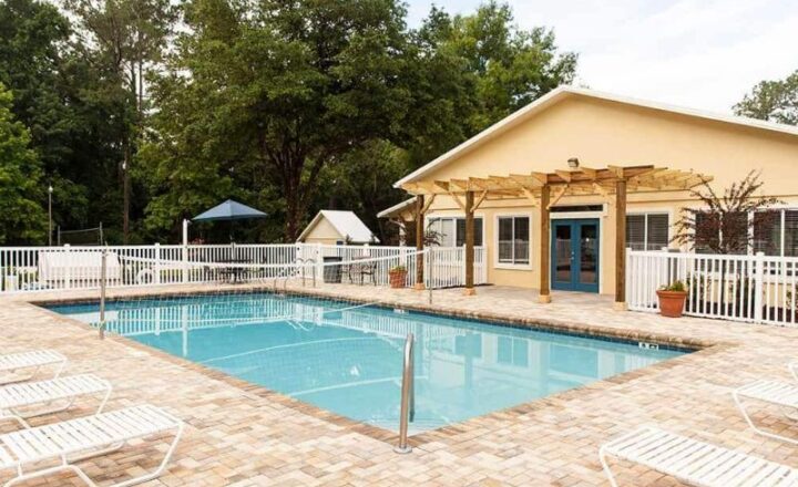 Outdoor swimming pool beside residential buildings at The Refuge in Florida