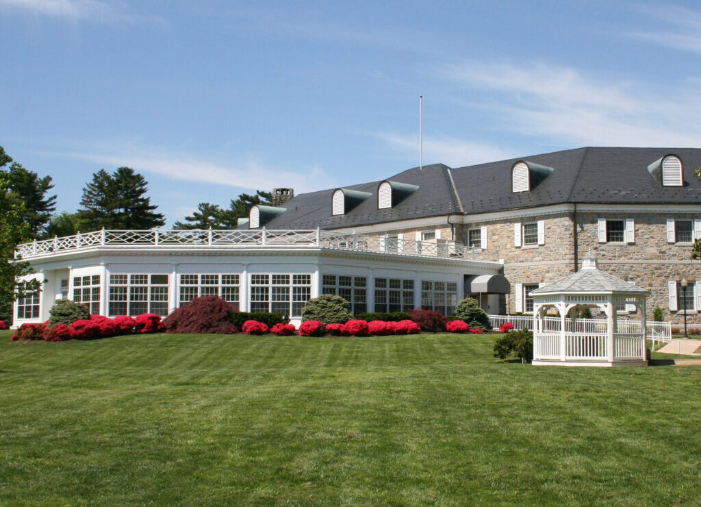 Stone campus building, flower beds and lawn at Ashley Addiction Treatment in Havre de Grace