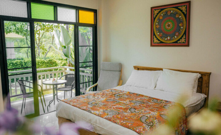 Bedroom with garden-facing terrace at The Beekeeper House in Chiang Mai