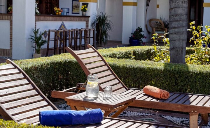 Sun loungers beside the pool at Camino Recovery