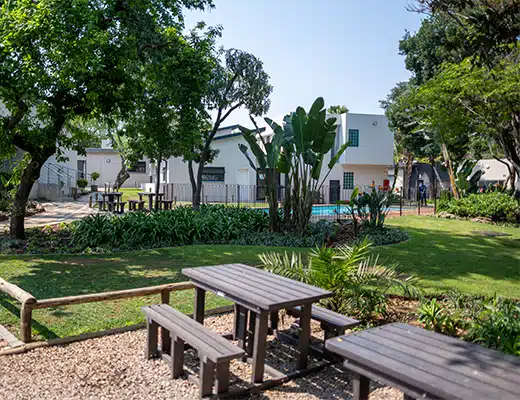 Garden seating and pool beside the main Houghton House treatment building in Randburg