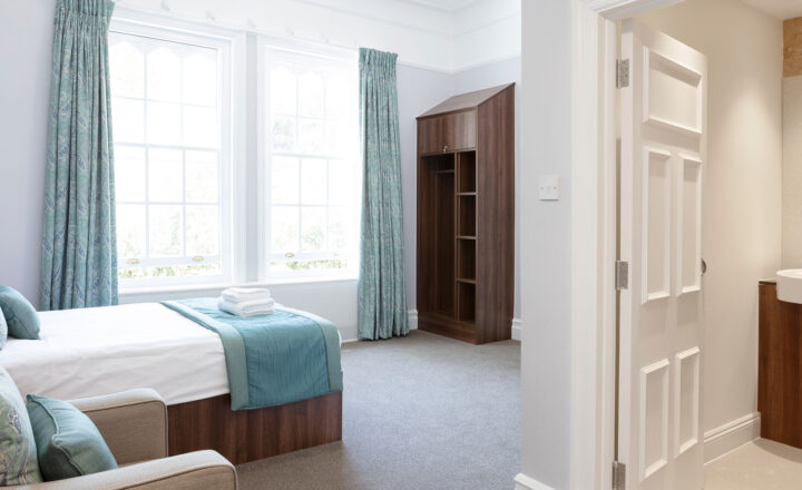 Bedroom and en-suite bathroom at Priory Hospital Roehampton