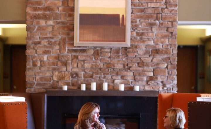 Provider photograph of seating and a fireplace in a Sibcy House common area