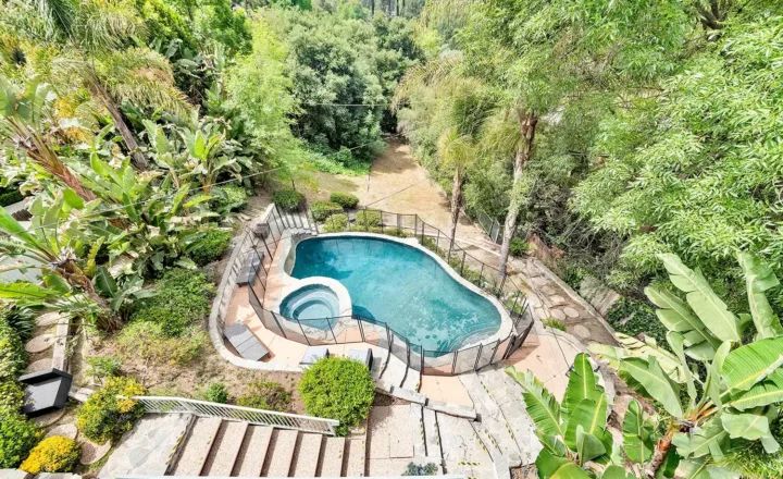 Outdoor swimming pool and gardens at The Villa Treatment Center