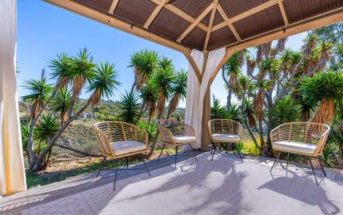 Covered garden seating at Villa Kali Ma’s Carlsbad residence