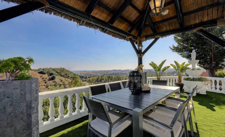Covered outdoor seating with coastal views at Villa Paradiso Spain