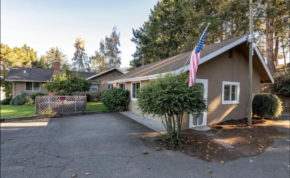 Olympia House Rehab farmhouse and landscaped lawn in Petaluma