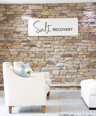 Salt Recovery branded stone wall and lounge seating at the Gold Coast residence