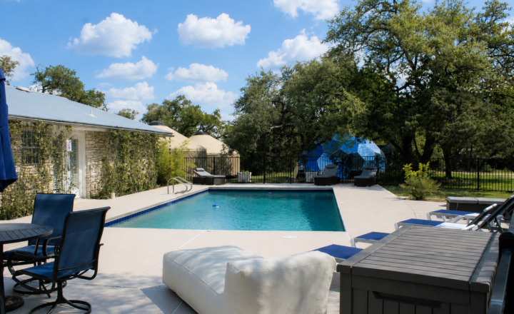 Pool and grounds at WITHIN Center's AWKN Ranch residential campus in Austin, Texas