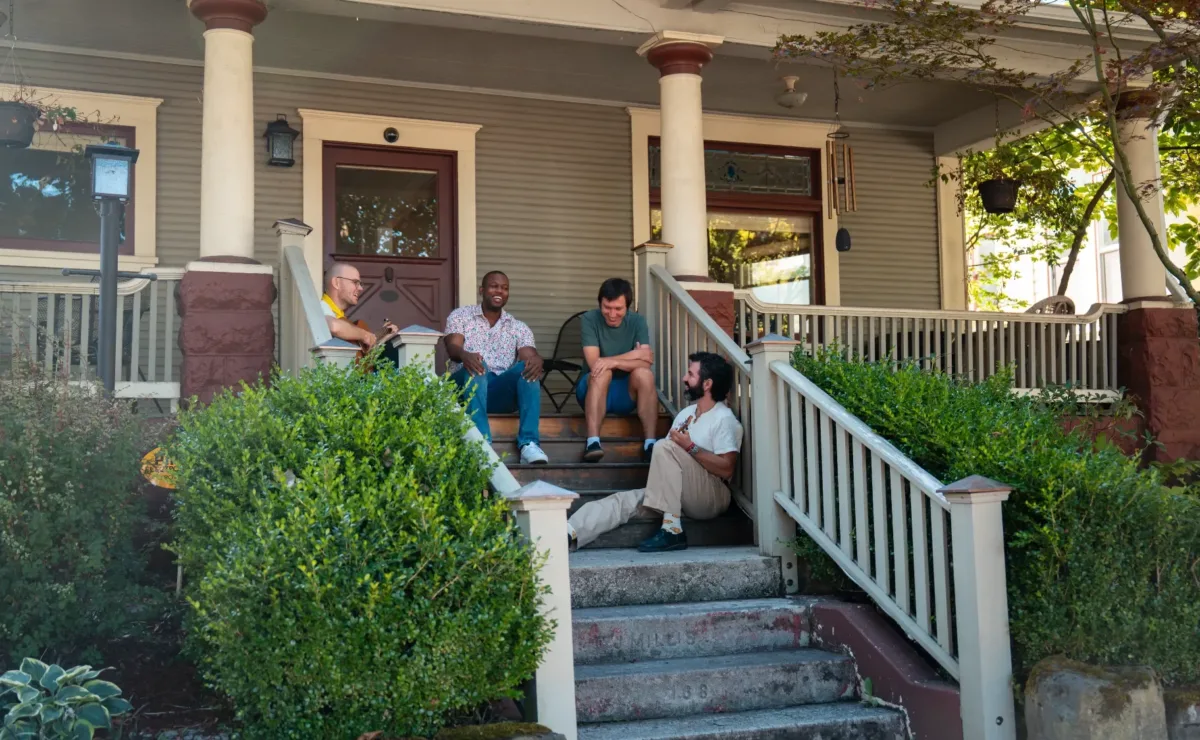 People seated outside a Windhorse Portland community residence